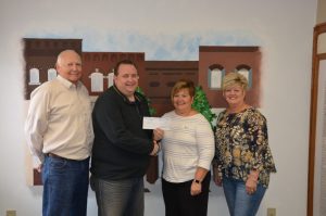 Photograph of presenting a check.