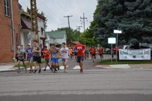 Photograph of a group of kids running up the street.