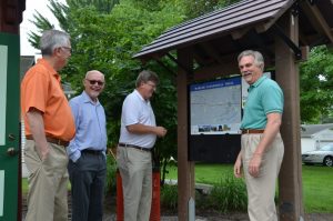 Photograph of a Wabash Cannonball Trailhead with community members standing next to it.